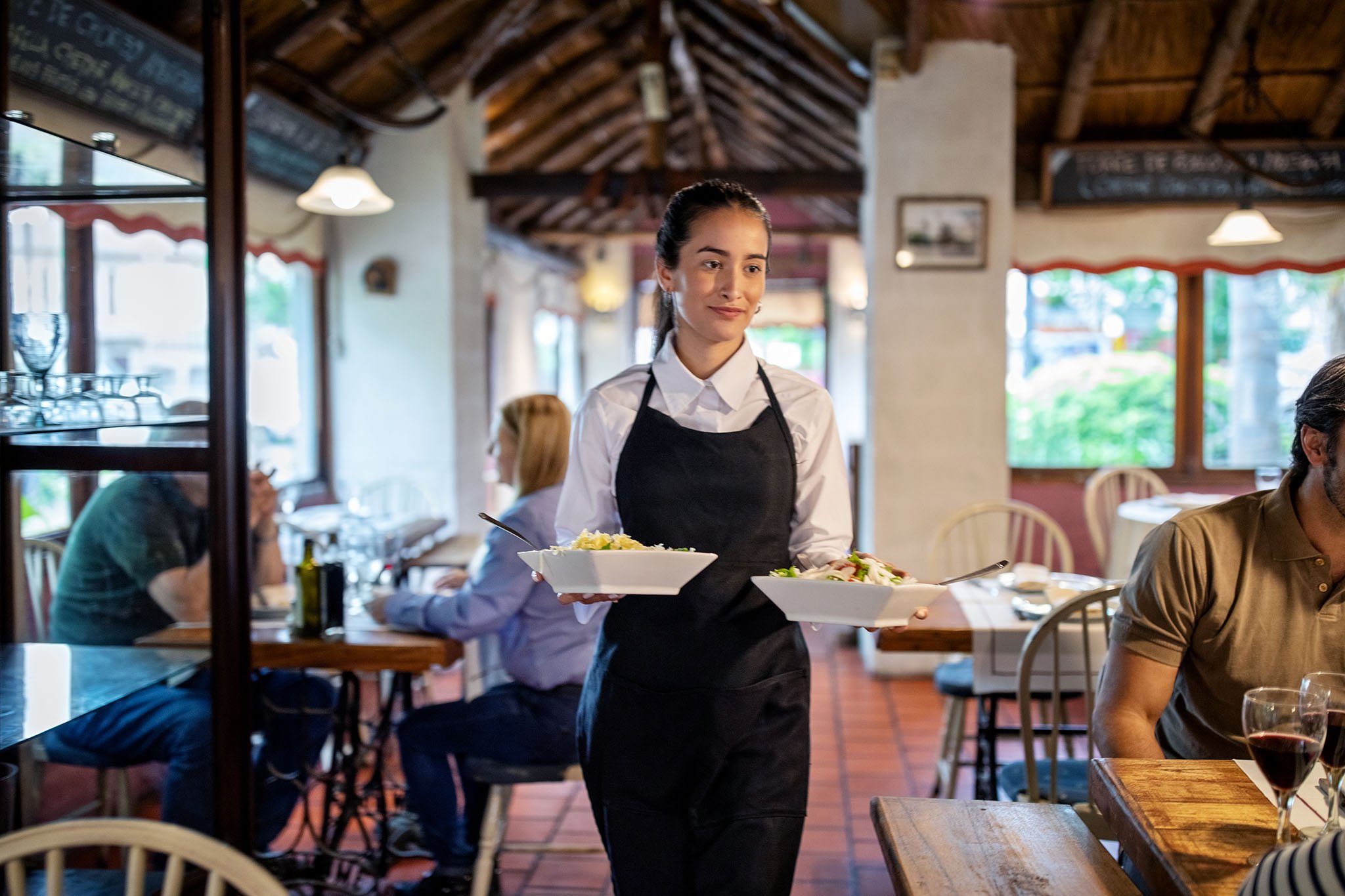 Waitress walking between tables