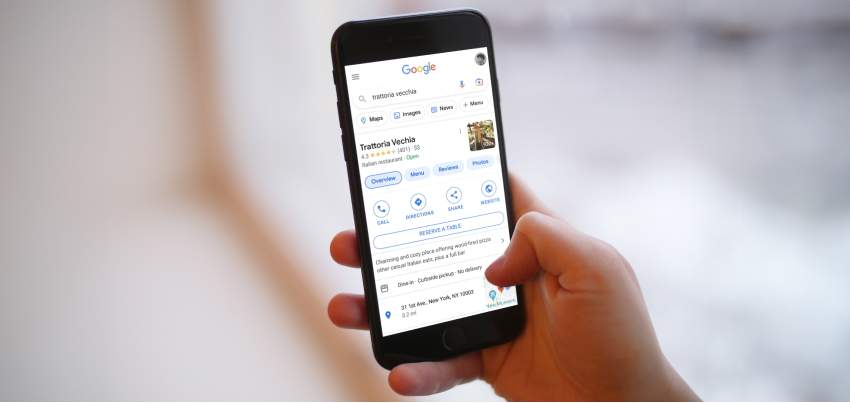 Image of a phone displaying a Trattoria in Google search results