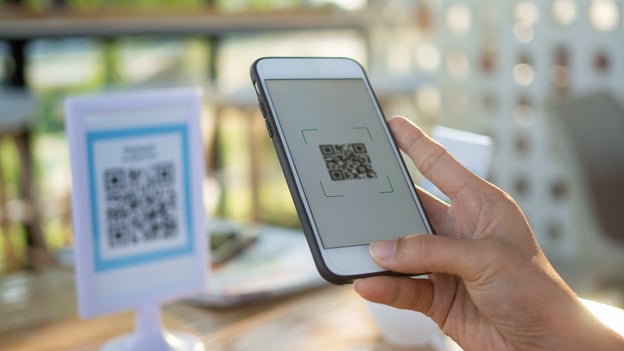 Person scanning a QR code