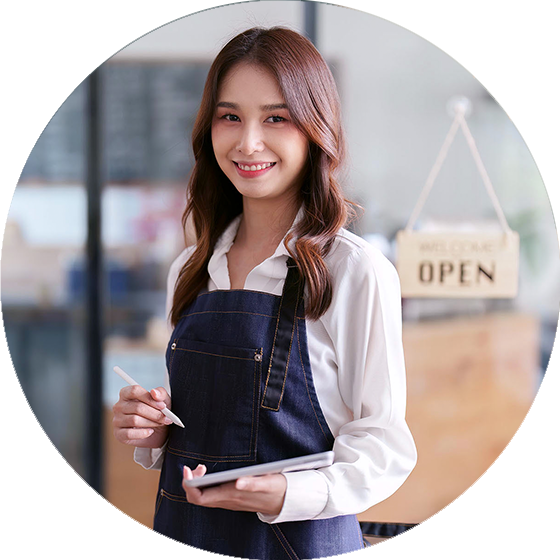 A waitress standing next to a door with a sign that says 'Open'. The waitress holding a tablet and smiling at the camera.